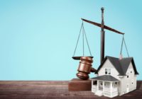 Judge's gavel and house model with copyspace over background. Justice and law concept