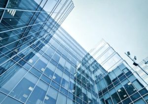 Panoramic and perspective wide angle view to steel blue background of glass high rise building skyscraper